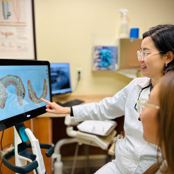 Dr. Kim showing a patient iTero digital scanner