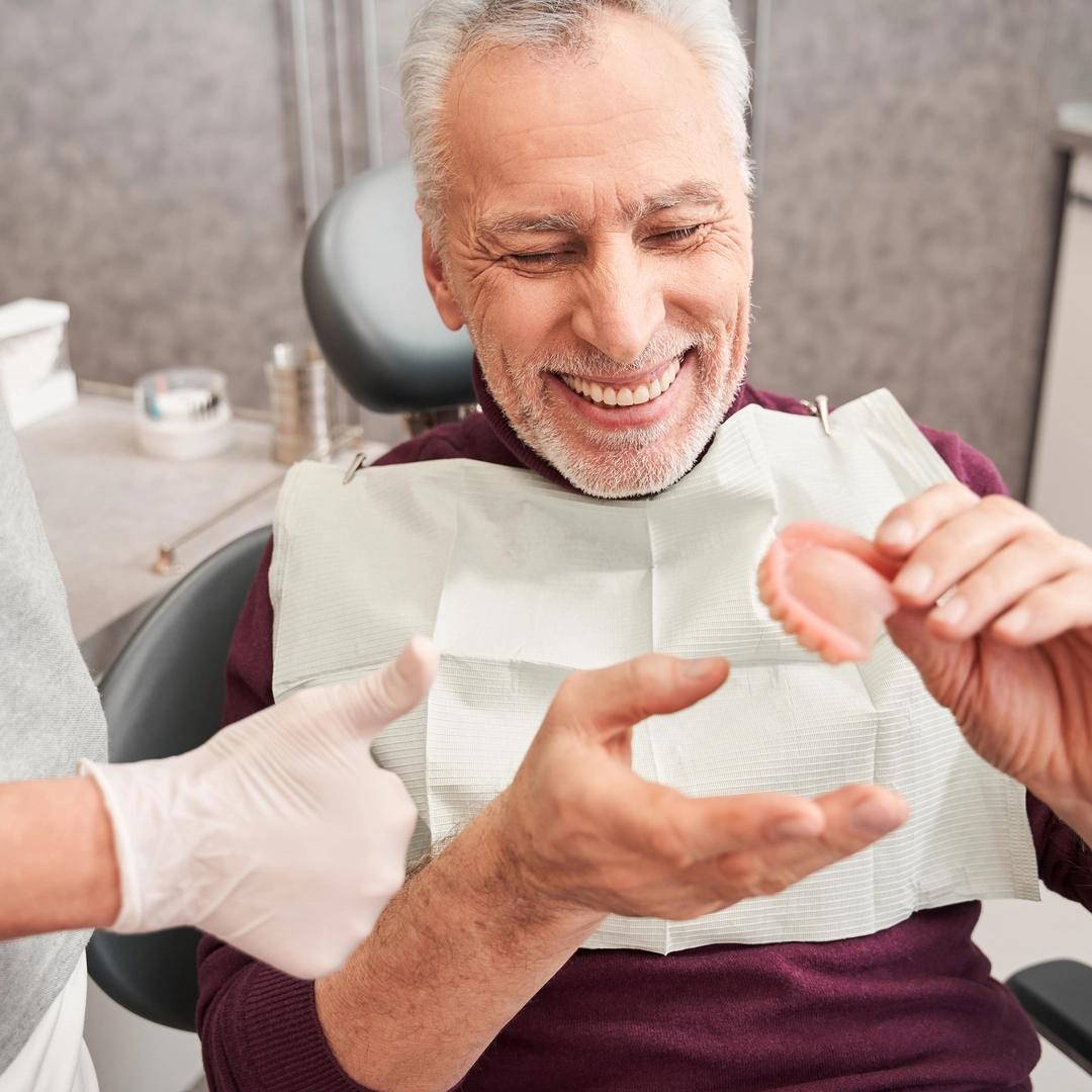 Patient smiling with comfortable dentures